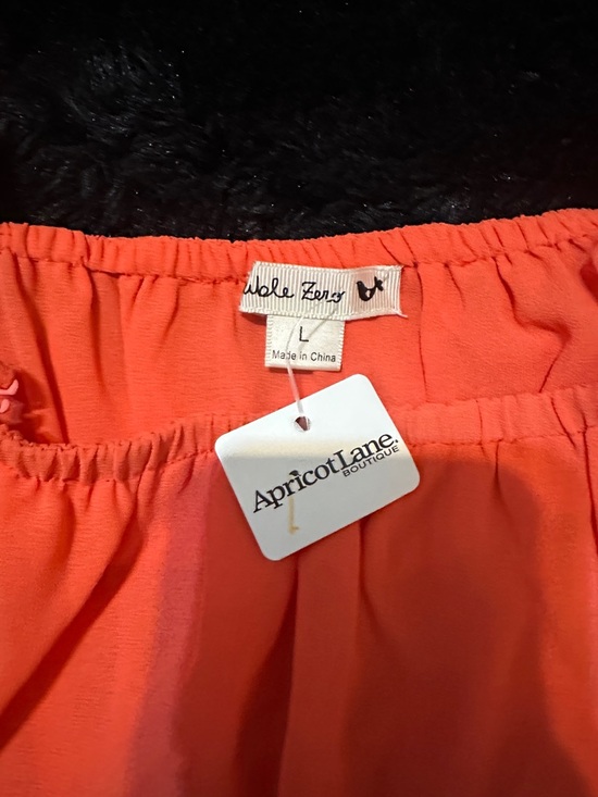 Coral Off-Shoulder Ruffle Dress from apricot lane. - Picture 2 of 2